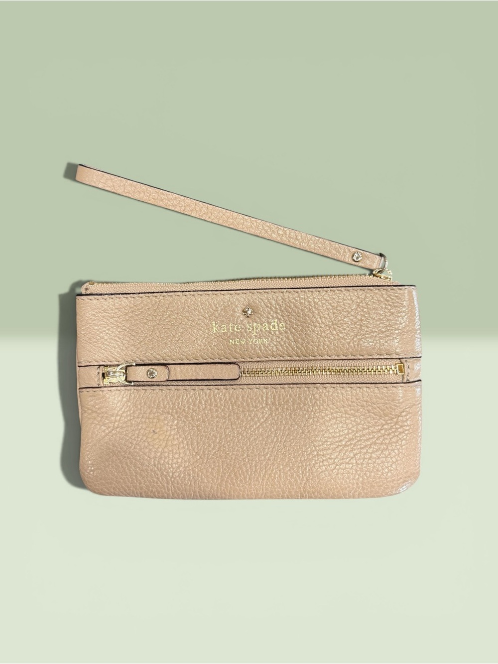 Kate Spade Beige Pebbled Leather Wristlet with Front zipper pocket.